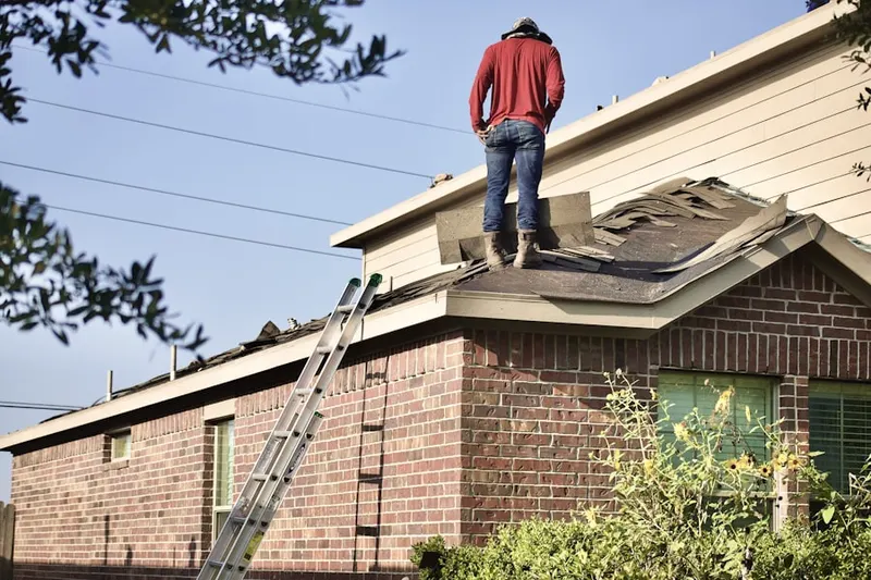 Professional roofer working on a residential roof in Achenbach